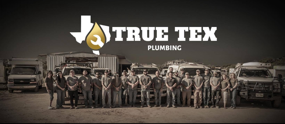 The True Tex Plumbing team standing with their service trucks in San Angelo, Texas